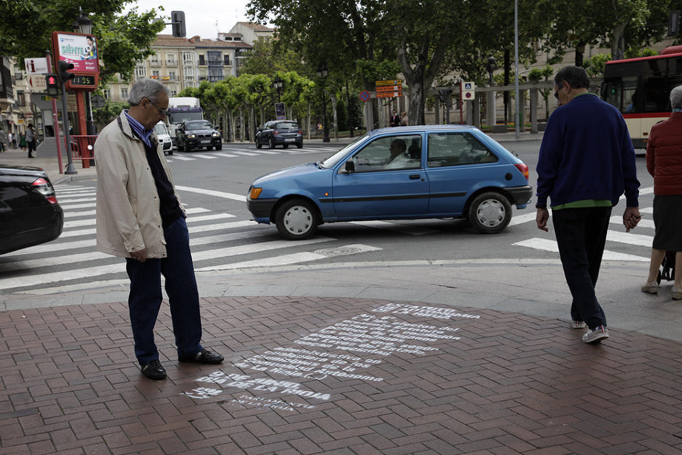 Un ciudadano observa uno de los artículos del Estatuto de Autonomía pintado en el suelo. / Ingrid