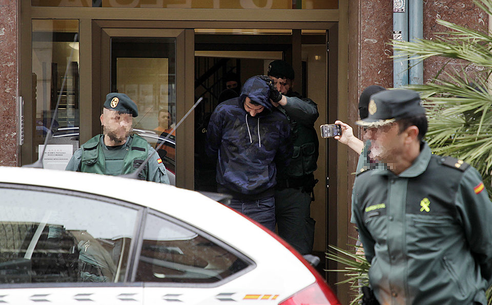 Agentes de la Guardia Civil trasladan a uno de los detenidos a su salida del edificio de Marqués de Murrieta. / Ingrid
